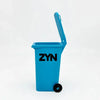 A bright blue mini desk organizer trash can with a hinged lid is shown against a white background.