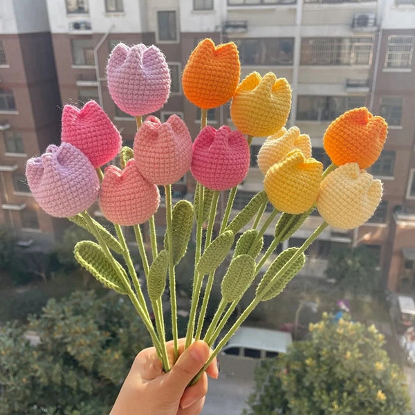 A bouquet of handmade cotton carnation flowers in shades of pink and orange.