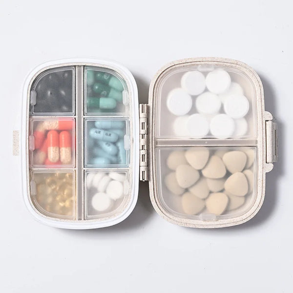 A portable pill organizer with eight compartments showing various colored and white pills.