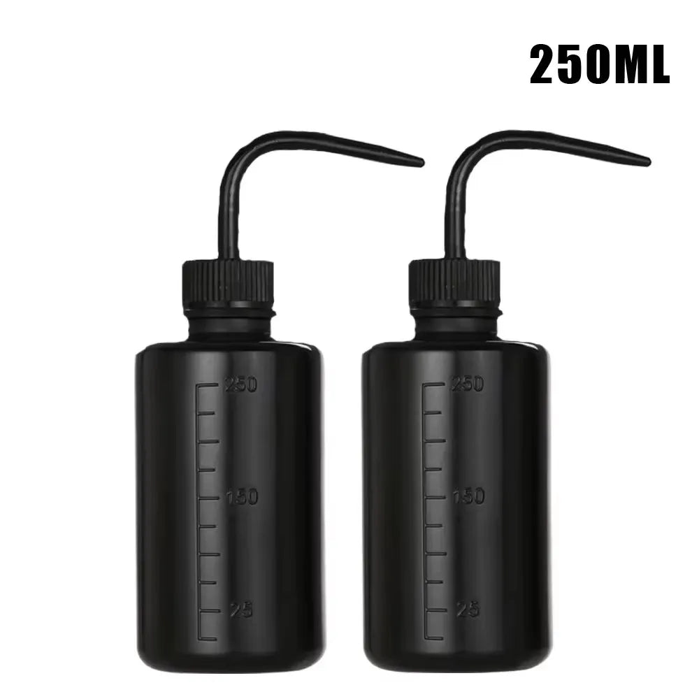 A pair of black squeeze bottles with measurement marks for tattoo solutions, labeled 250ml.
