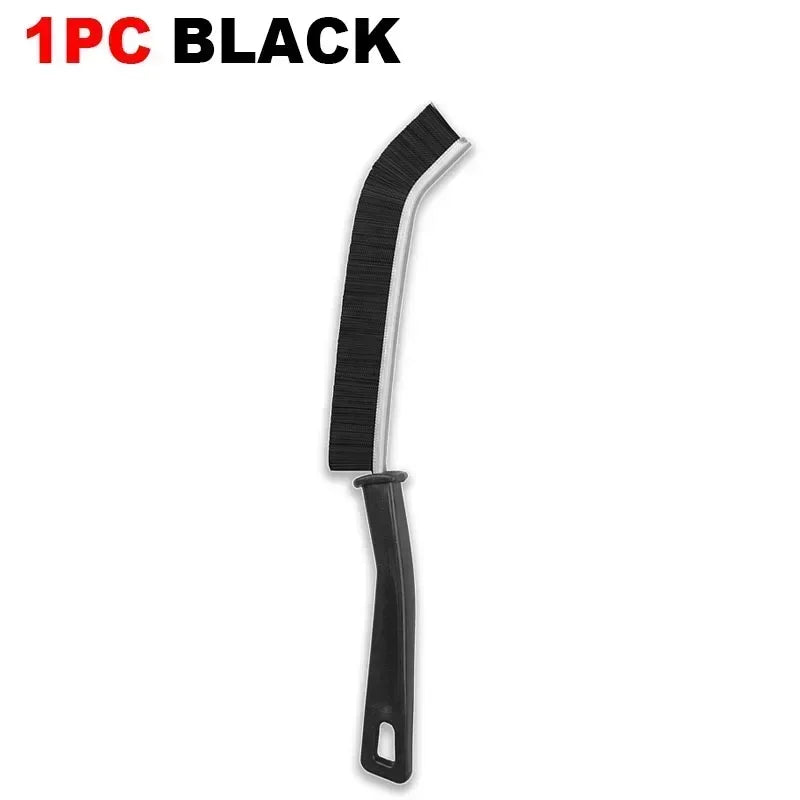A black durable hard-bristle crevice cleaning brush.