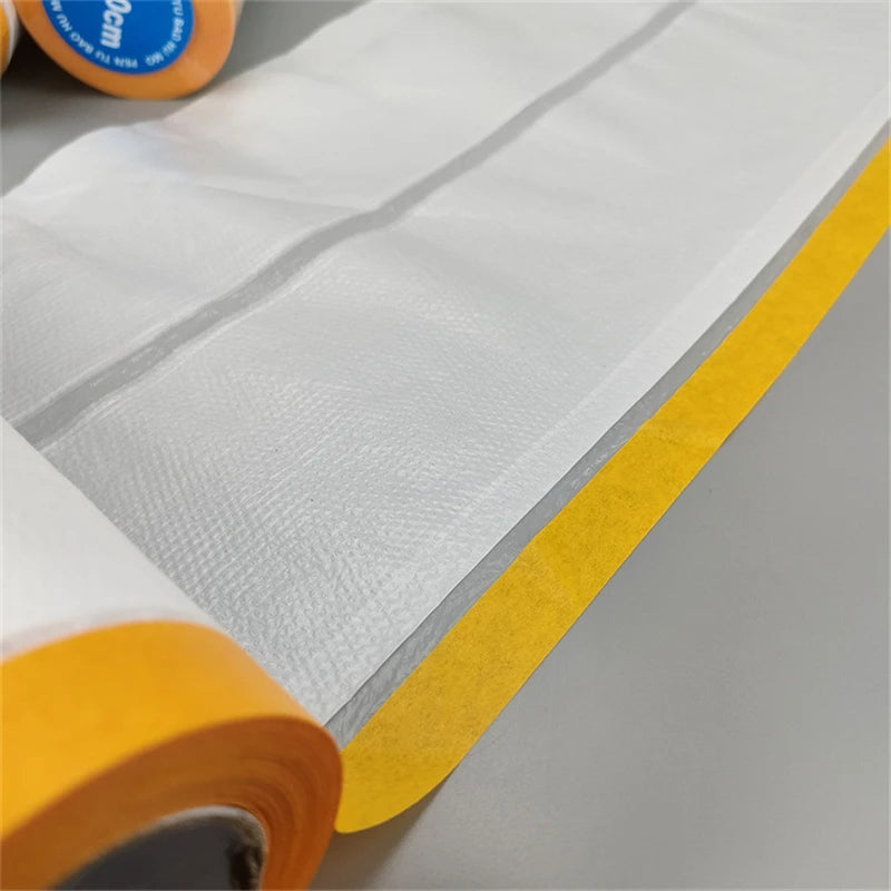 Roll of clear masking film with yellow edge used for painting and protection.