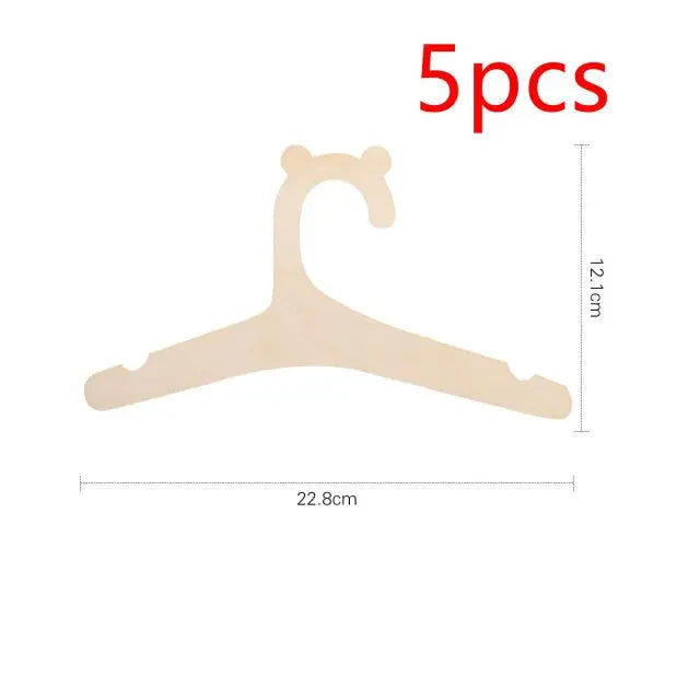 Five pieces of light wood clothing hangers designed for kids and apparel.