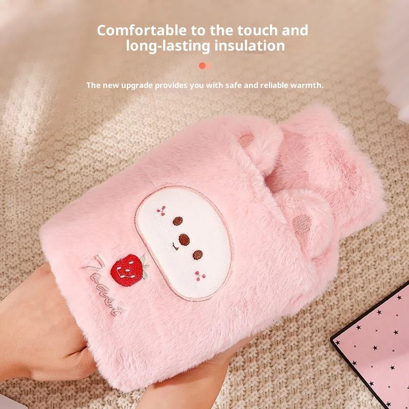 A pink plush animal hot water bottle with a strawberry design is shown being held by a hand.