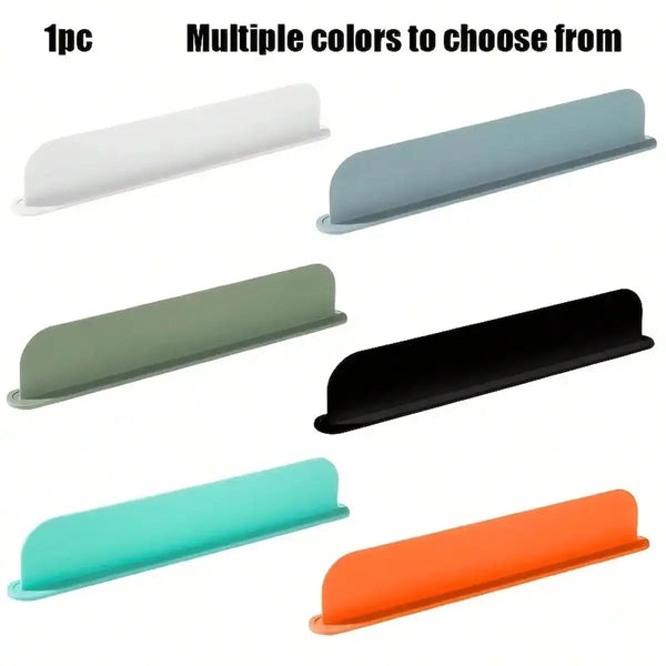 A set of five silicone sink splash covers in various colors including white, light blue, green, black, and orange.