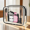 A clear travel organizer pouch containing various makeup and grooming tools like brushes and a comb.