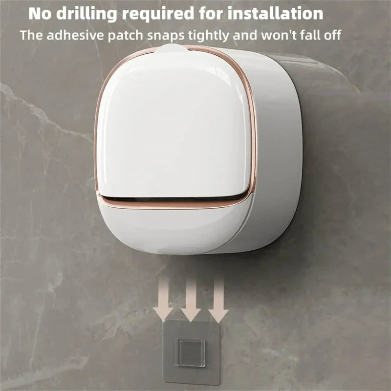 A white wall-mounted soap holder with a lid is shown being installed onto a gray wall.