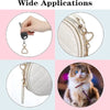 A set of heart-shaped spring hook keychains shown being used on a hand and attached to a leather bag and a cat's collar
