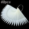 A set of 40 false nail tips in a fan shape, white and translucent, with a metal loop for attachment.