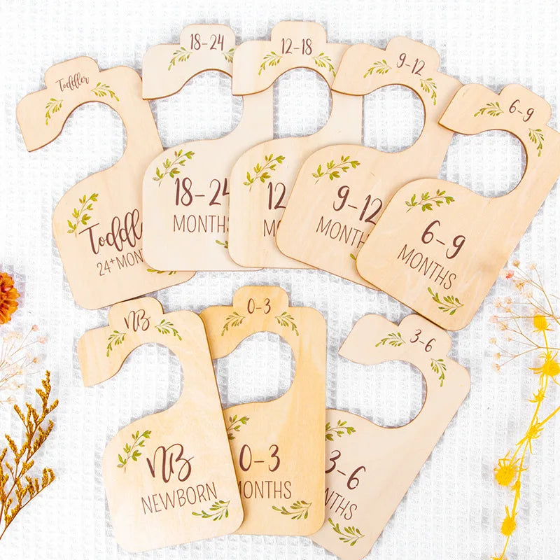 A set of natural bamboo closet dividers shaped like unicorns for organizing clothing.