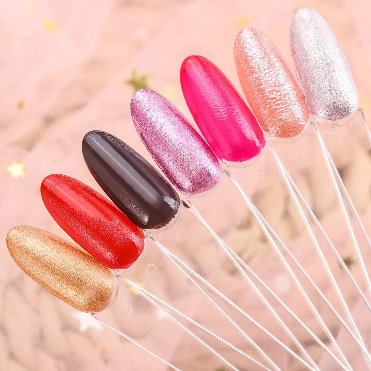 A set of colorful nail art practice false tips in various shades including pink, red, and glitter finishes.