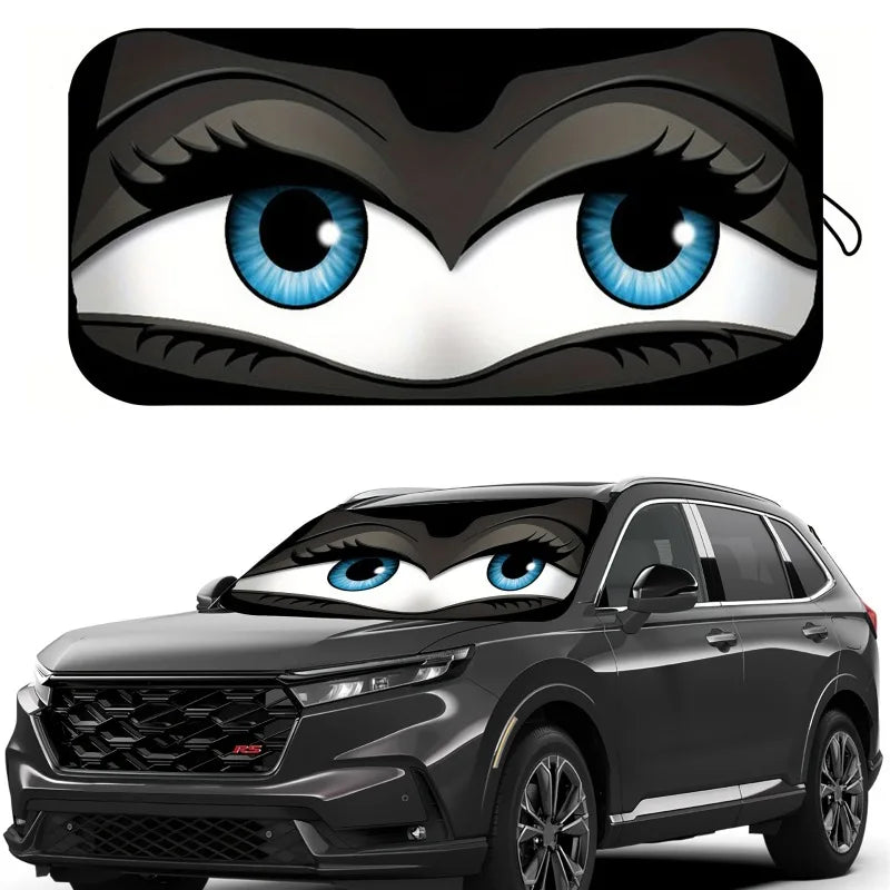 A cartoon eye design featuring blue irises and black fur is placed on a car windshield.