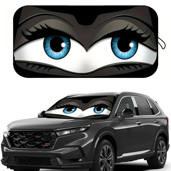 A cartoon eye design featuring blue irises and black fur is placed on a car windshield.