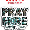 Una pegatina con el texto PRAY MORE Worry Less en una fuente desgastada y texturizada.