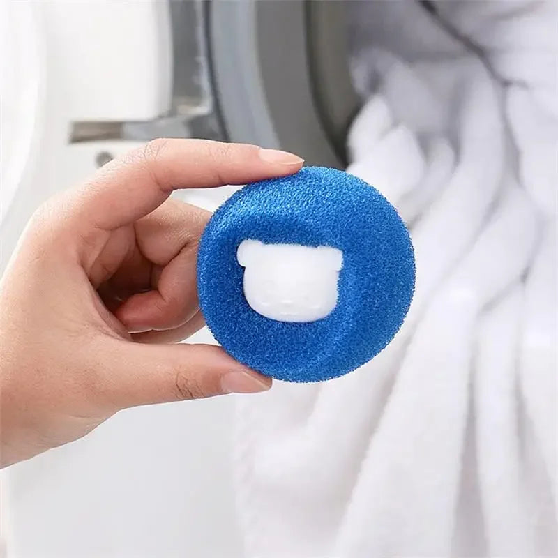 A hand holds a blue laundry ball with a white catcher, used for pet hair removal.