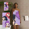 A woman models a glitter purple chibi anime beach towel featuring multiple cute characters.