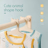 A wooden animal shape hook clothing hanger is shown hanging on a wooden rod, with a light-colored garment nearby.