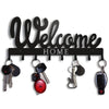 Black decorative metal key holder rack with hooks displaying various keys and a house sign