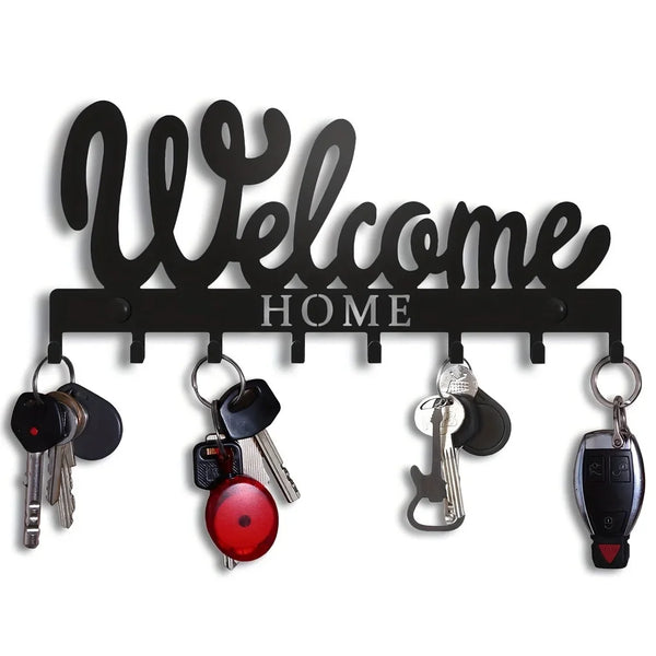 Black decorative metal key holder rack with hooks displaying various keys