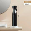 A black 300ml multi-functional handheld spray bottle standing on a shelf next to a mirror.