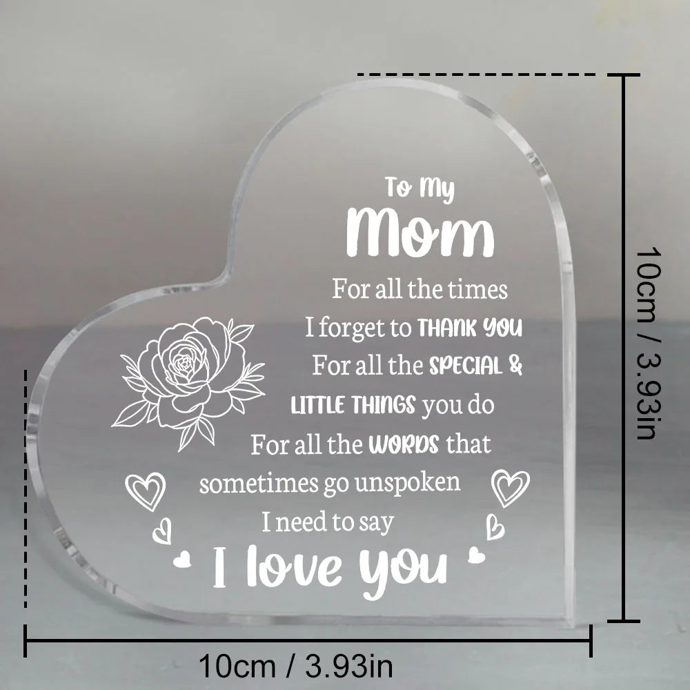 A clear acrylic heart-shaped keepsake engraved with the message I love you Mom for her special and little things.