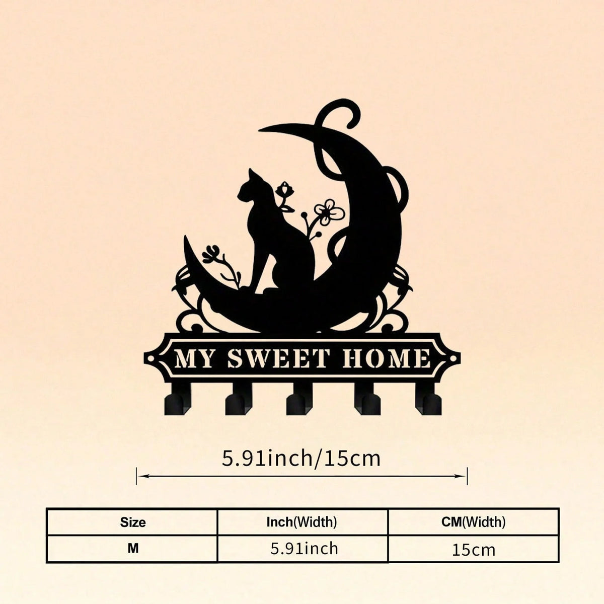 A black silhouette of a cat sitting on a crescent moon, used as a rustic metal wall hook key holder.