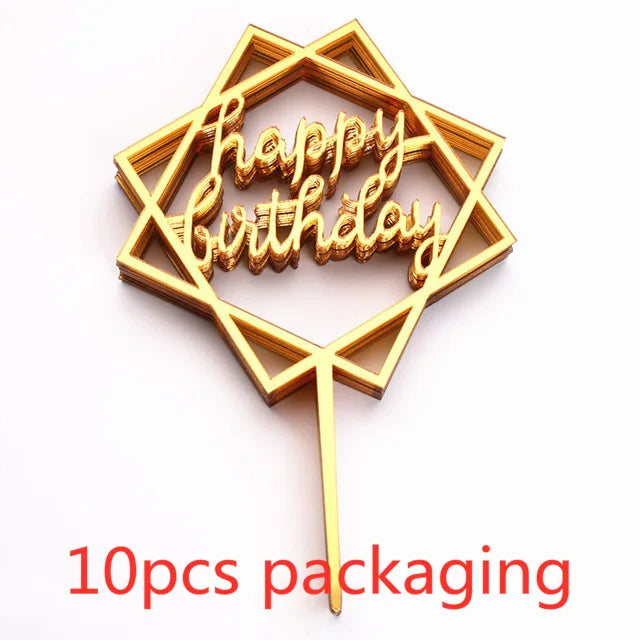 A gold-colored acrylic birthday cake topper shaped like a menorah with the words Happy Birthday on it, shown against a white 