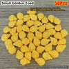 50 pieces of small golden toad decorative ornaments laid out on a gray surface