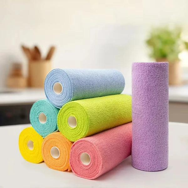 A collection of colorful reusable microfiber cleaning wipes in various shades of green, yellow, and pink stacked on a white s