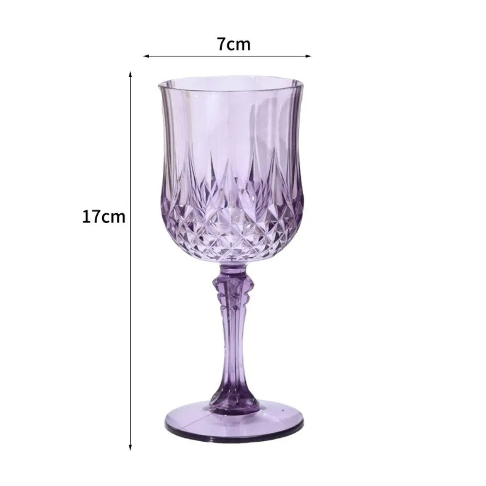A clear purple plastic champagne flute with a stem and foot.