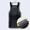 A black waterproof transparent kitchen apron hanging on a hanger with a pocket detail.