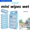 A pack of disposable mini wipes in a blue and white package with a bear design shown outdoors.