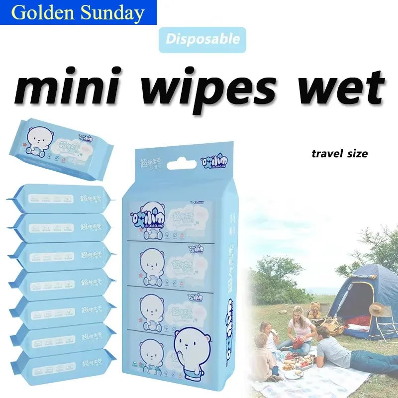 A pack of disposable mini wipes in a blue and white package with a bear design shown outdoors.