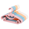 A set of portable plastic clothes hangers in pastel colors pink, orange, and blue.