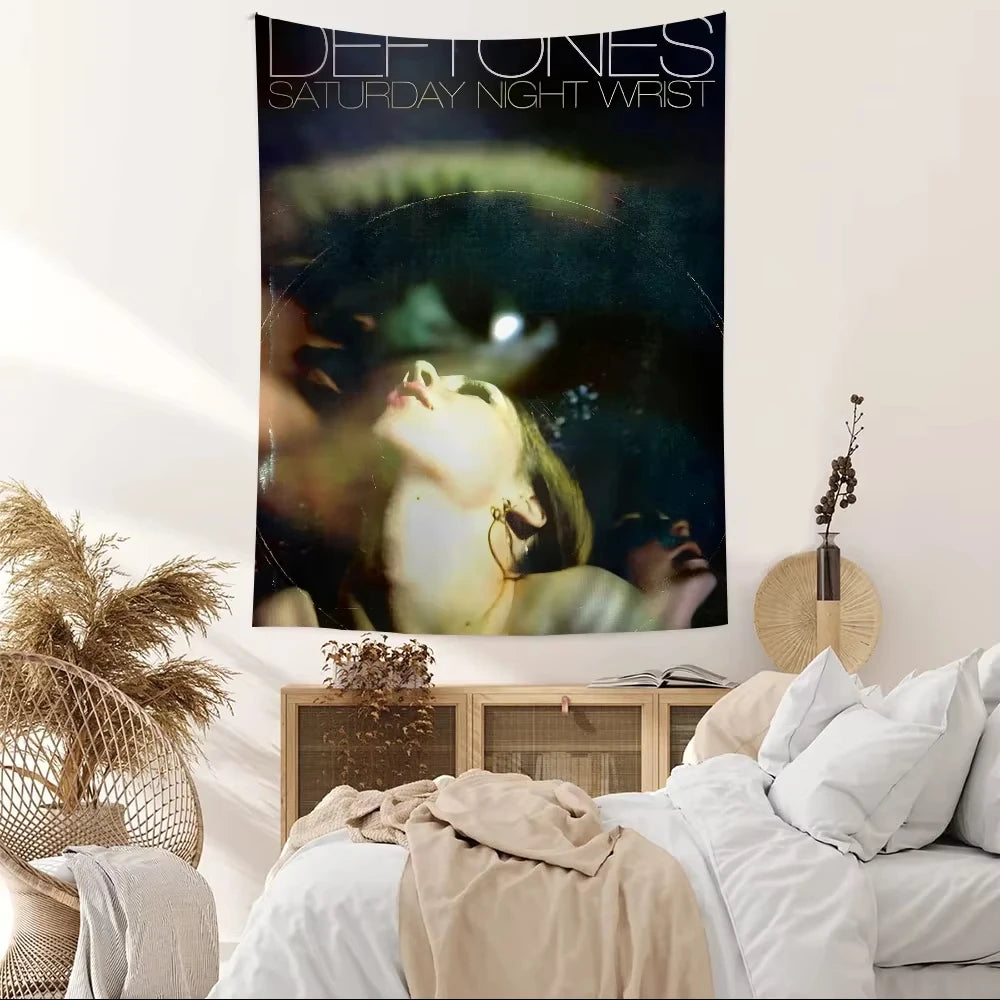 A dark tapestry featuring the text Deftones Saturday Night Wrist and an image of a person's face.