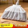 A white disposable electrostatic broom cover bag filled with light gray fibrous material, shown on a wooden surface.