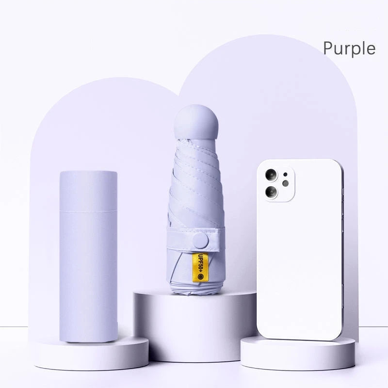 A purple folding UV protection umbrella and a white smartphone are displayed against a light background.