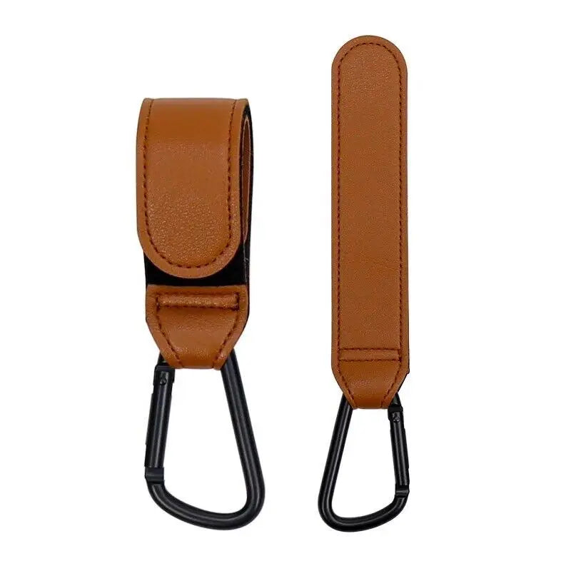 A brown leather strap with a hook and carabiner attached, used as a stroller hook accessory.