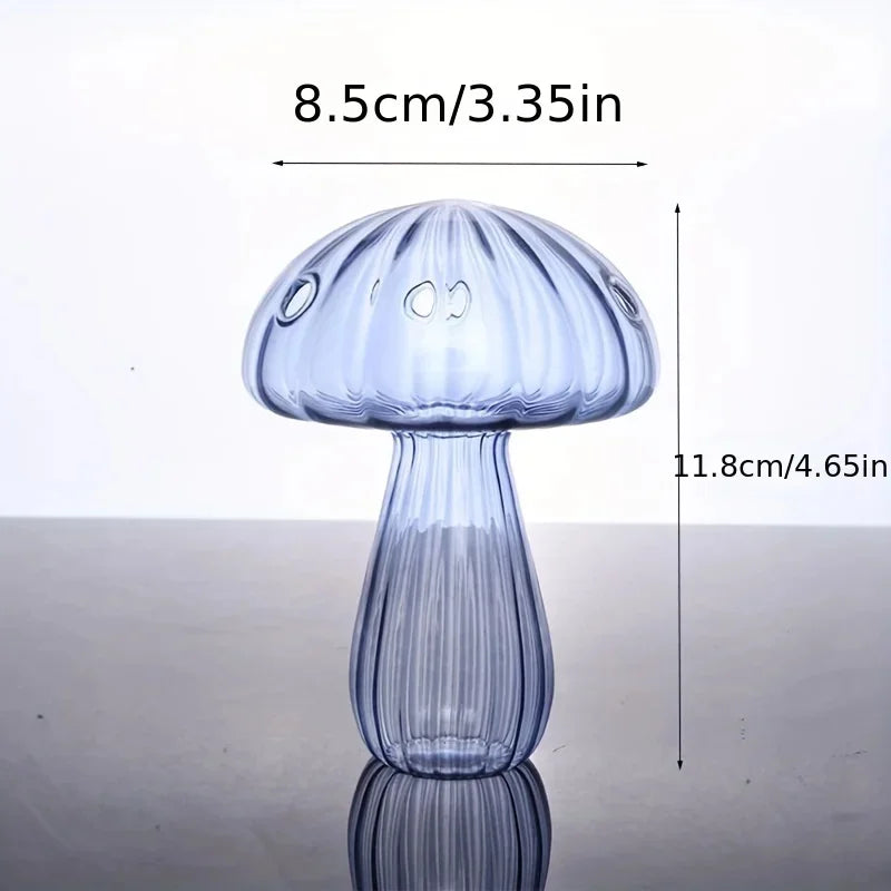 Clear glass mushroom vase with a rounded cap and tapered stem, shown against a light background.