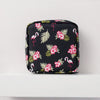 Black floral nylon sanitary pad storage pouch featuring pink hibiscus flowers and pink flamingos