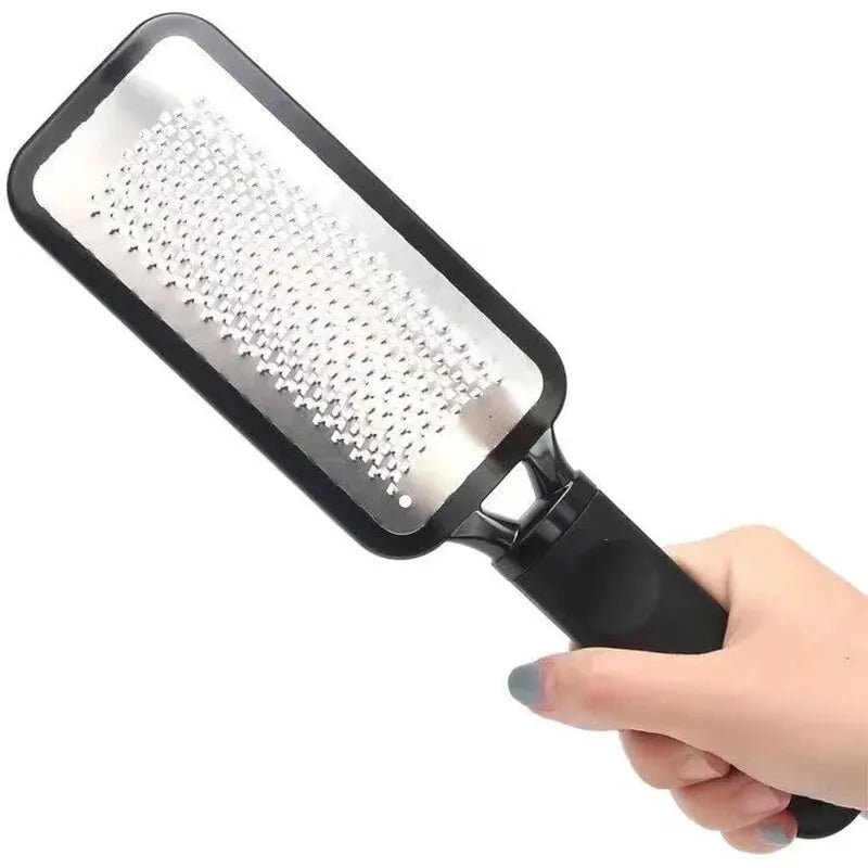 A close-up of a black foot file and callus remover tool being held by a hand.