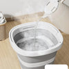 A white collapsible water bucket is being filled with water, demonstrating resistance to high temperature deformation.