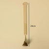 A beige portable toilet lid lifter tool with a long handle and a curved end.