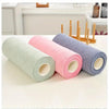 A set of reusable microfiber cleaning cloths in light green, pink, and gray are displayed on a white surface.