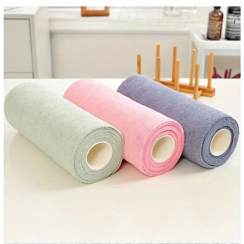 A set of reusable microfiber cleaning cloths in light green, pink, and gray are displayed on a white surface.