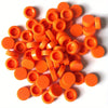 A collection of round, orange building blocks or connectors for DIY projects.