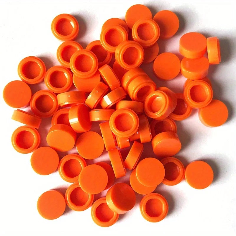 A collection of round, orange building blocks or connectors for DIY projects.
