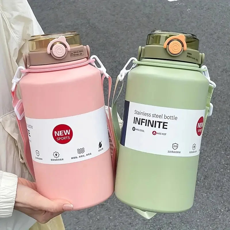 A pink insulated stainless steel water bottle with a lid and straw is held by a person, next to a green one.