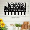 Black silhouette wall sign featuring the name John and the phrase My Sweet Home with a rustic metal hook design