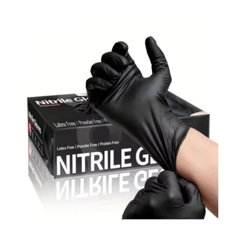 A black disposable nitrile cleaning glove is shown on a hand, ready for use.